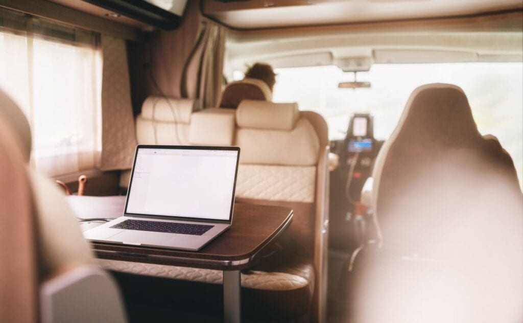 Camper van converted to workspace for freelance work on the road. Mobile home van filled with natural light