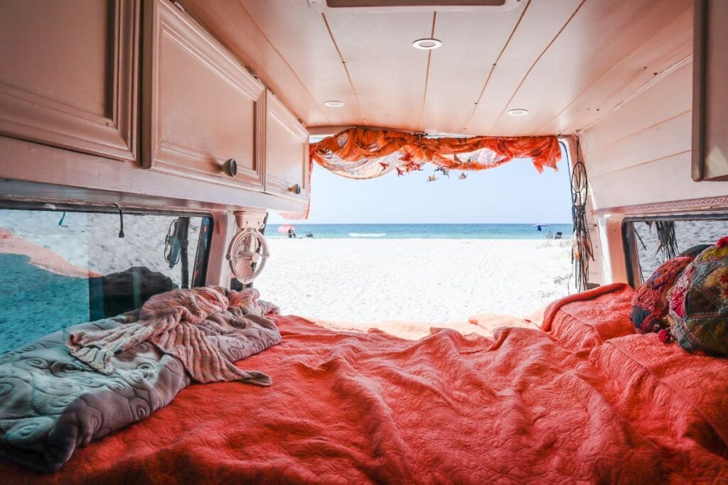 INside of camper van with red comforter