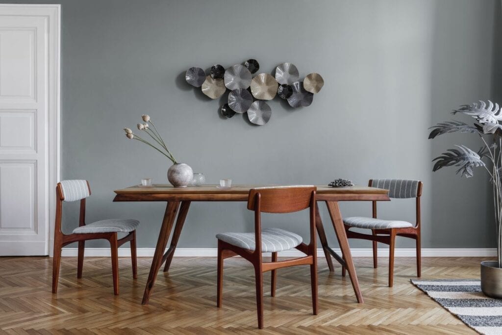 Dining room with modern sculpture wall art