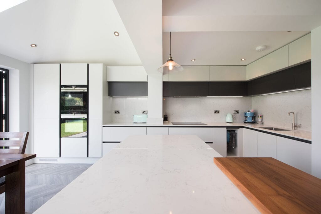 A general view of a an open plan kitchen diner with large island counter within a home