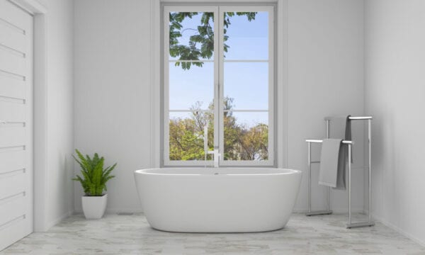 Modern bathroom with tub in front of large window