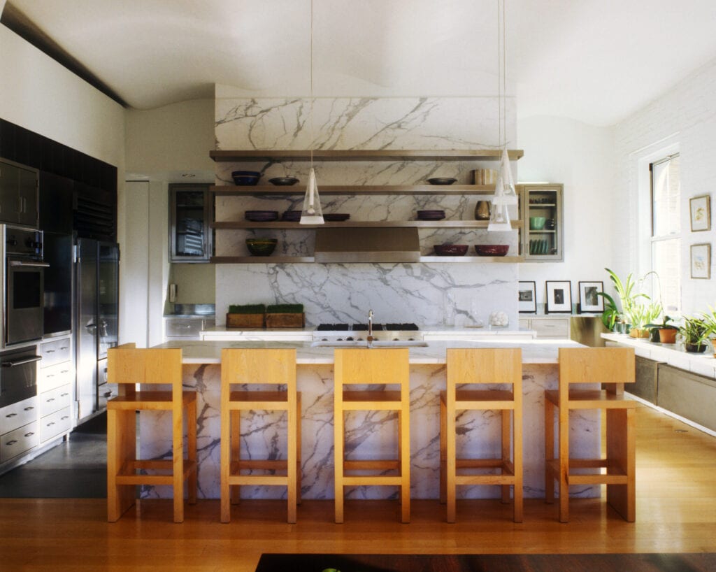 Marble countertops and facings in a kitchen with a Viking range and Spencer Fung stools in this converted Tribeca loft designed by Richard Gluckman.