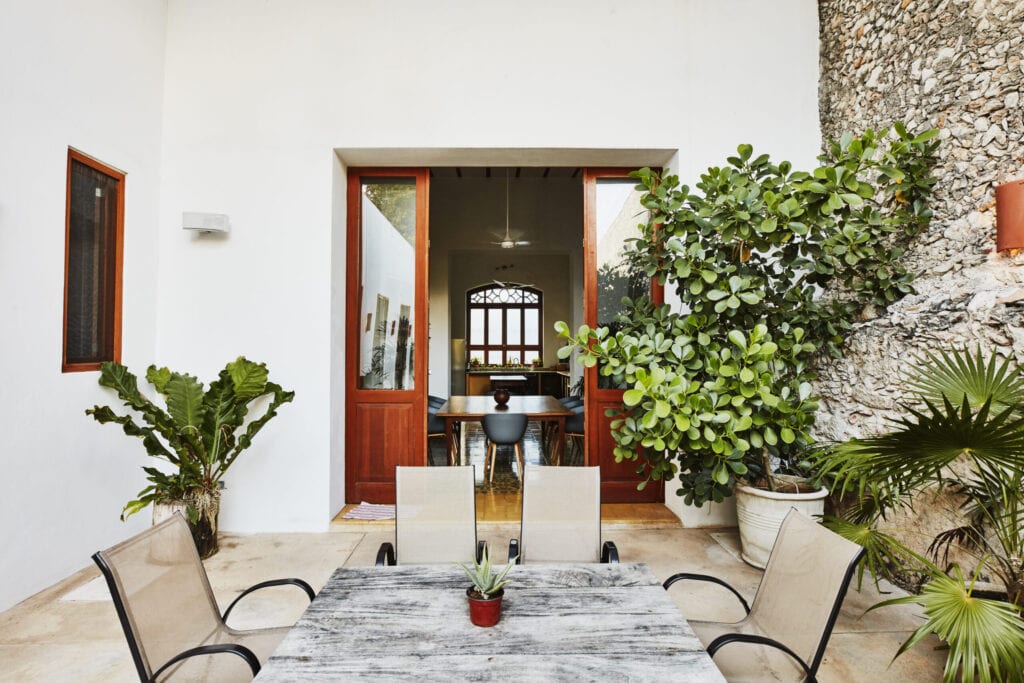 View from exterior courtyard into dining room of home