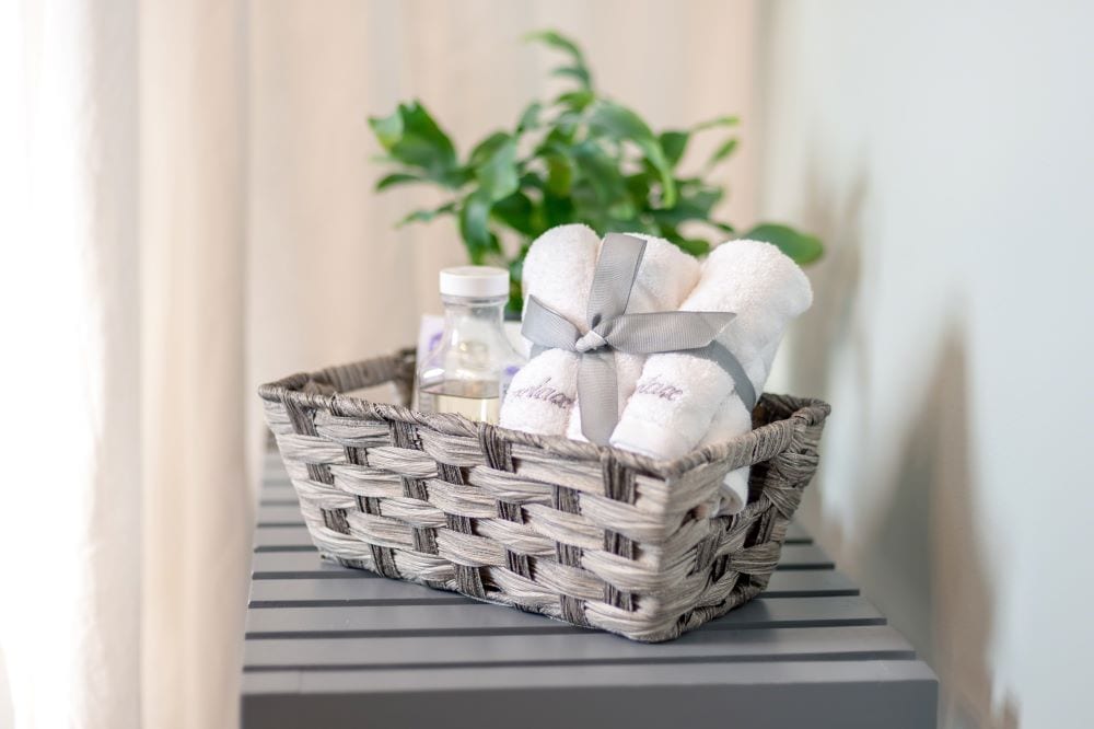 Basket holding small hand towels and lotion