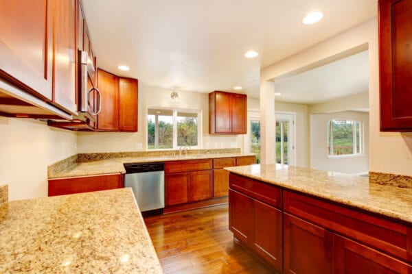 Nice wooden kitchen room interior with granite counter tops , hardwood floor and white ceiling. Northwest ,USA