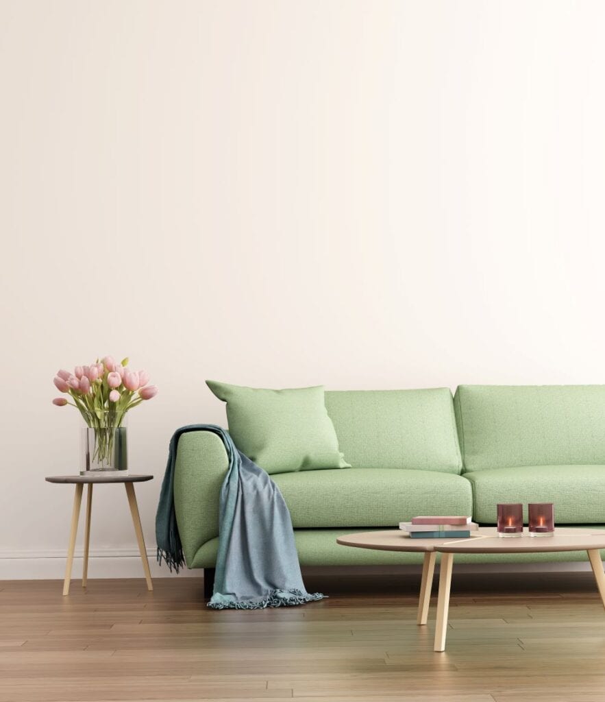 Sage green couch in neutral living room