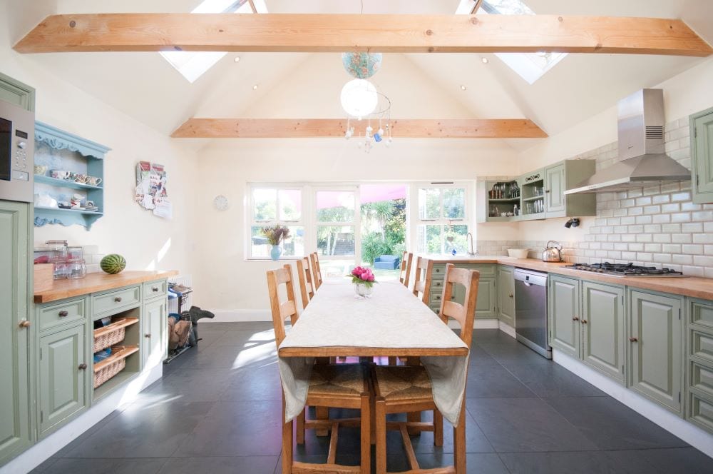 Beautiful kitchen and dining area with sage green cabinets