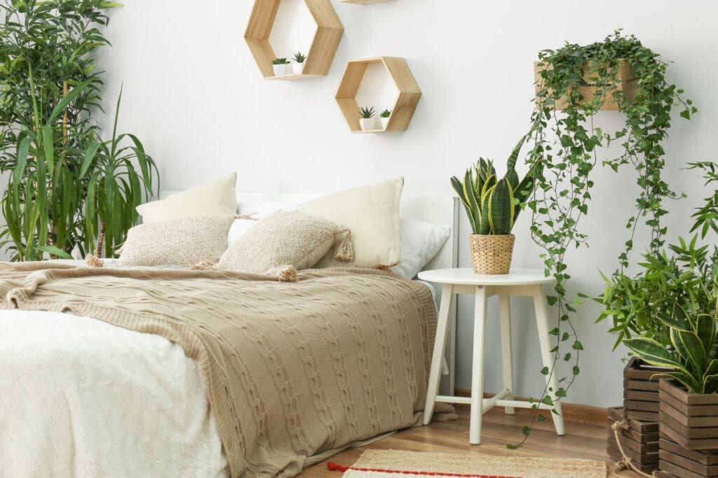 Bedroom filled with indoor plants, homemade boxes used as planters