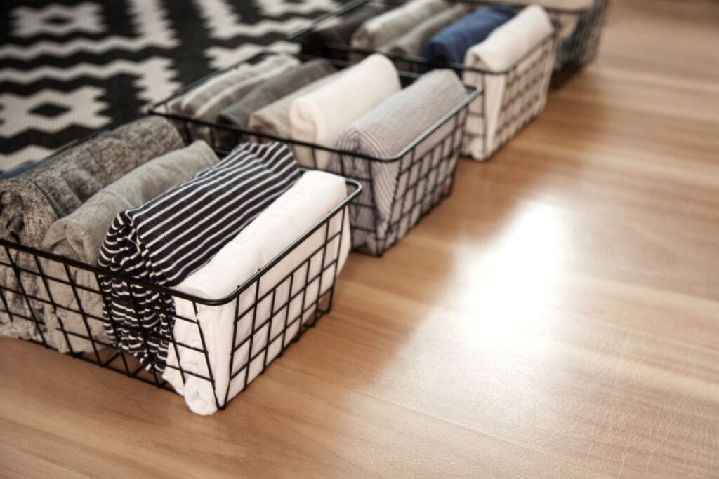 Clothes folded and stored in minimalist wire baskets