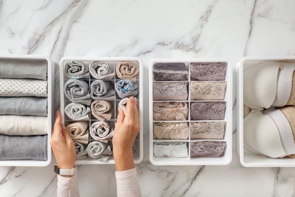 Clothes folded and rolled in drawer organizer