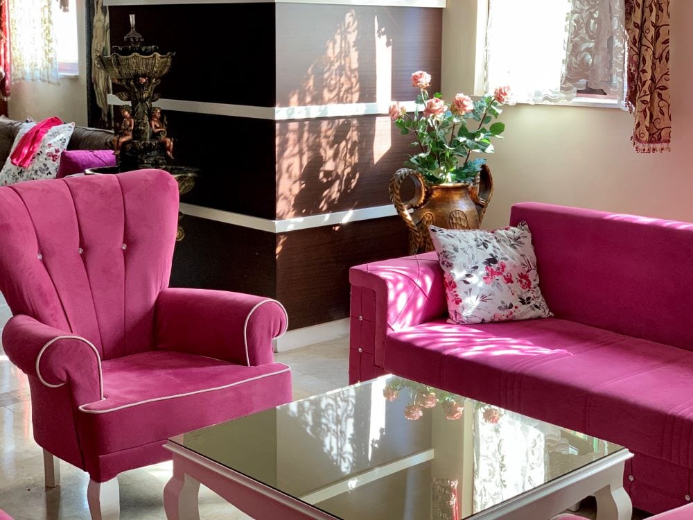 Living room with bright pink couch and chair