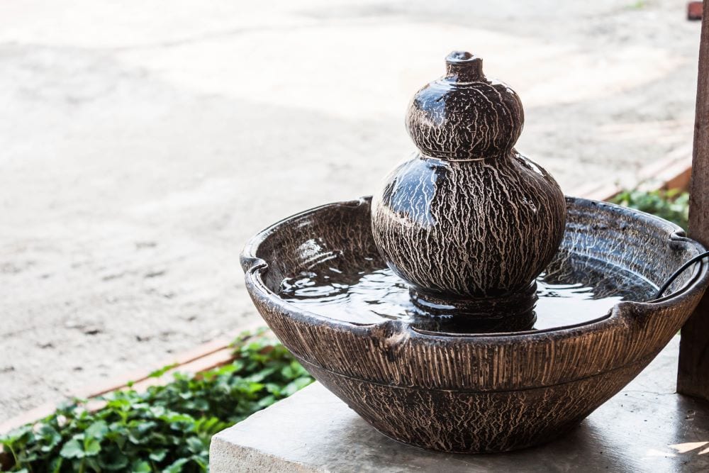 Small garden fountain water feature on table