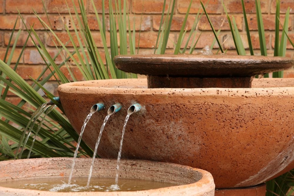 Stone vessel water feature with 3 spouts