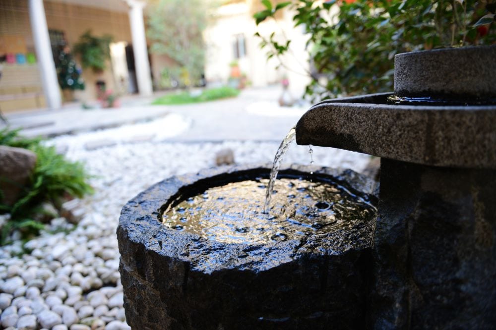 Stone water feature against rock background