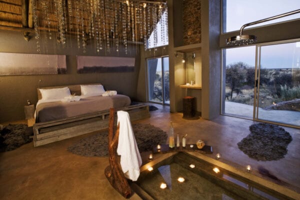 Luxury lodge bedroom interior with sunken bath in Namibia, Africa