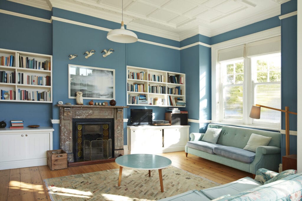 Bookshelf and fireplace in decorated living room at home