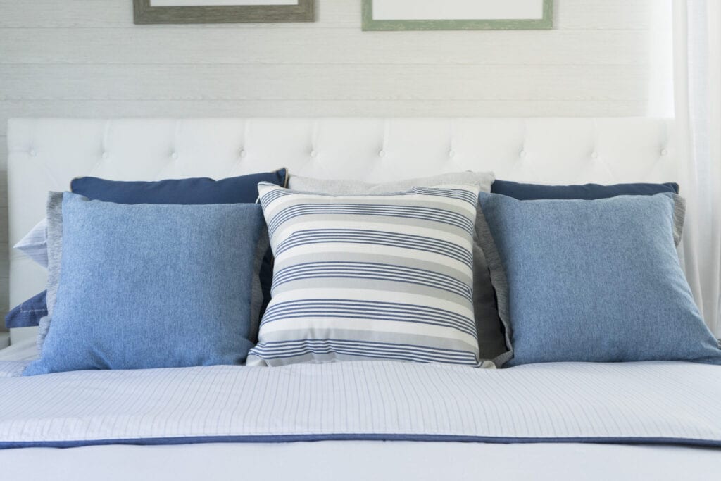 coastal blue cushion on bed in bedroom