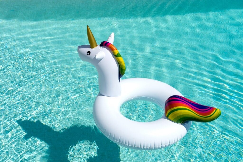 Unicorn shaped pool float in the middle of a swimming pool