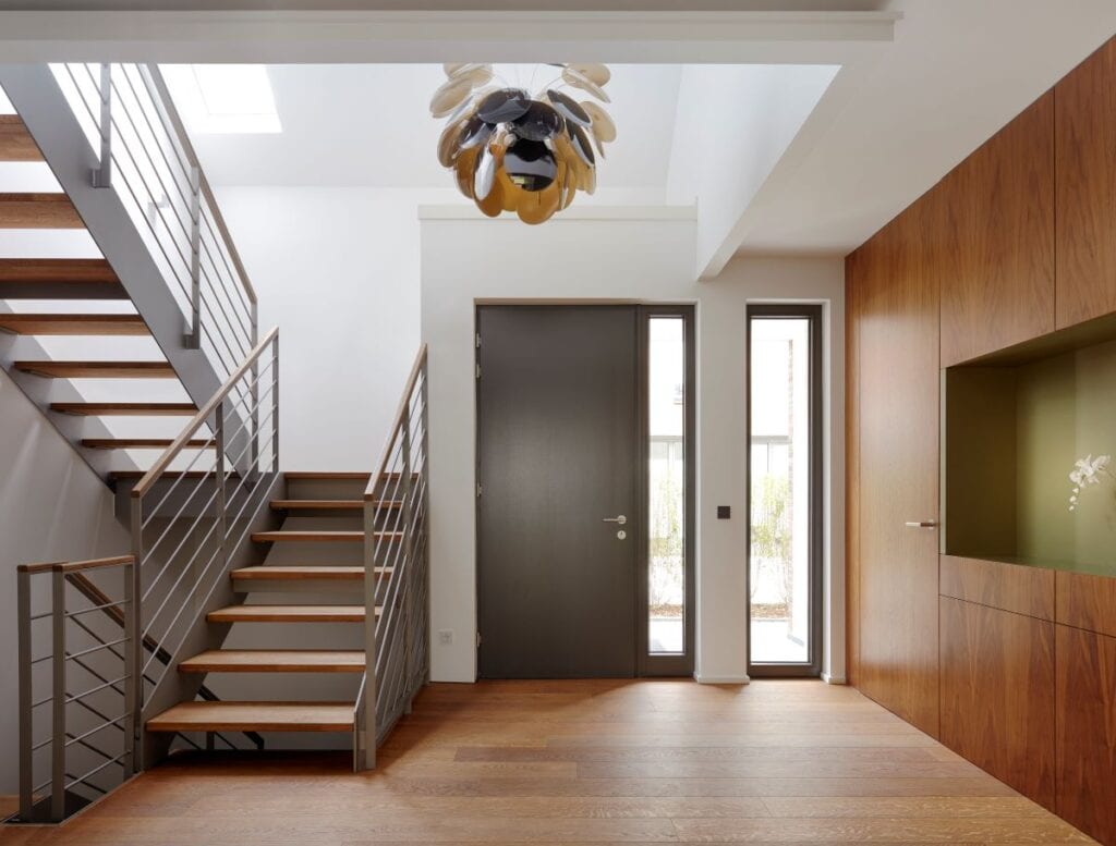 Modern foyer with staircase and unique chandelier