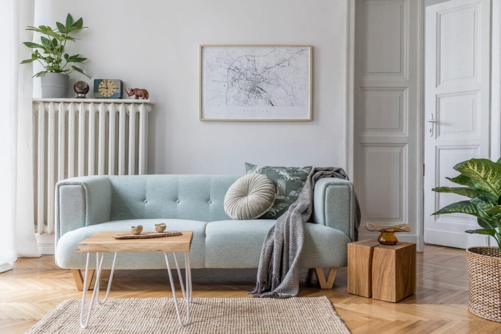 Modern scandinavian living room interior with stylish mint sofa, furnitures, mock up poster map, plants, and elegant personal accessories. Home decor. Interior design. Template. Ready to use.