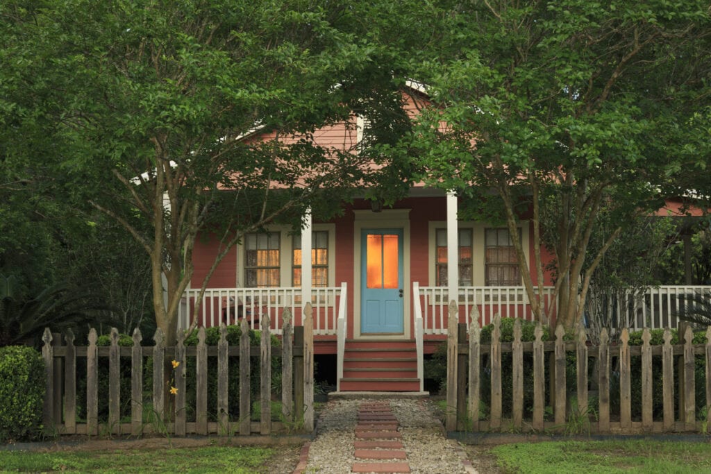 Cottage with weathered picket fence at twilight, Lousianna, USA