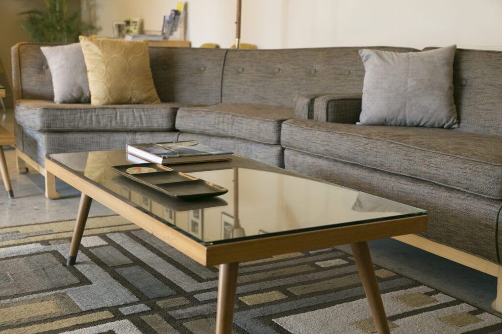 Coffee table with glass and sectional sofa