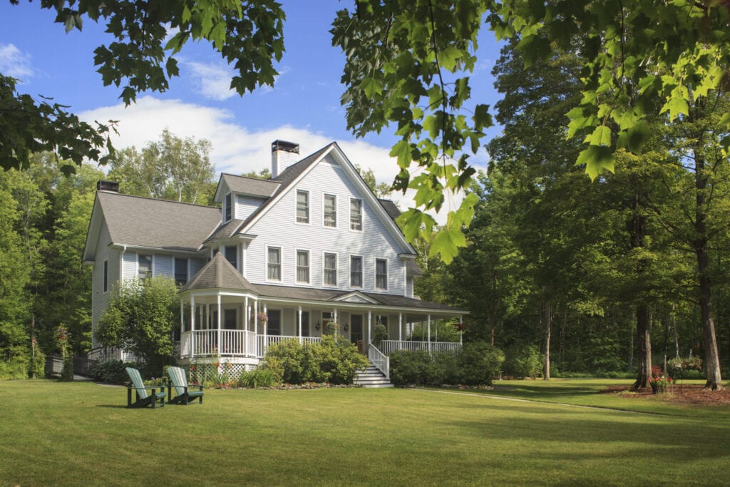 Victorian farmhouse home with lawn and large front porch in summer, Maple Leaf Inn, Barnard,Vermont, USA