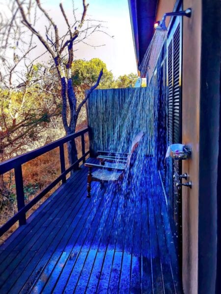 Outdoor shower on deck on the side of a house