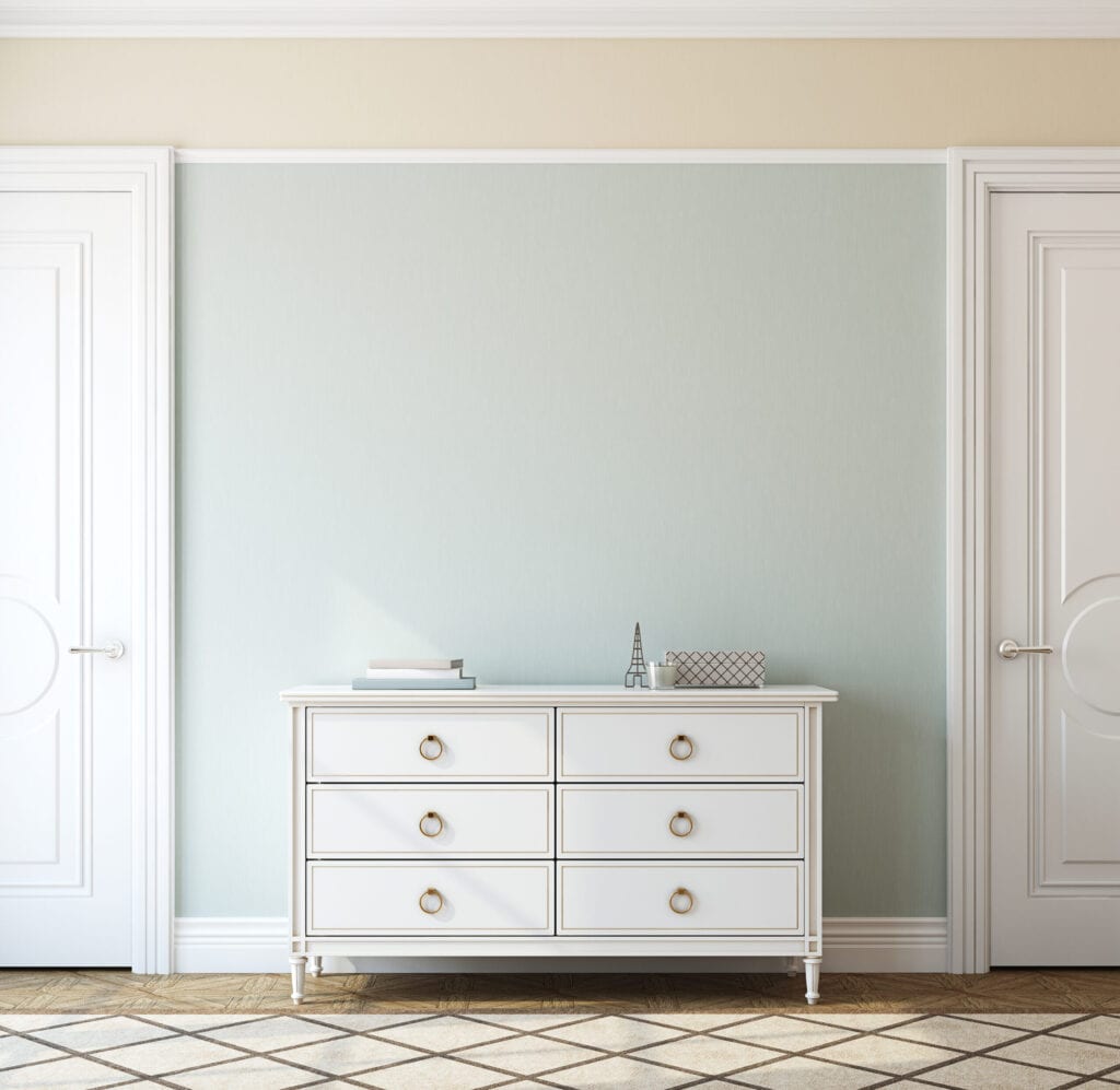 Interior of foyer with white dresser and light blue accent wall