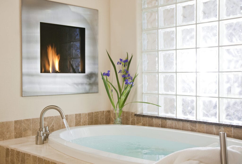 Bathtub in luxury inn with fireplace, Inn on Lake Granbury, Granbury, Texas, USA