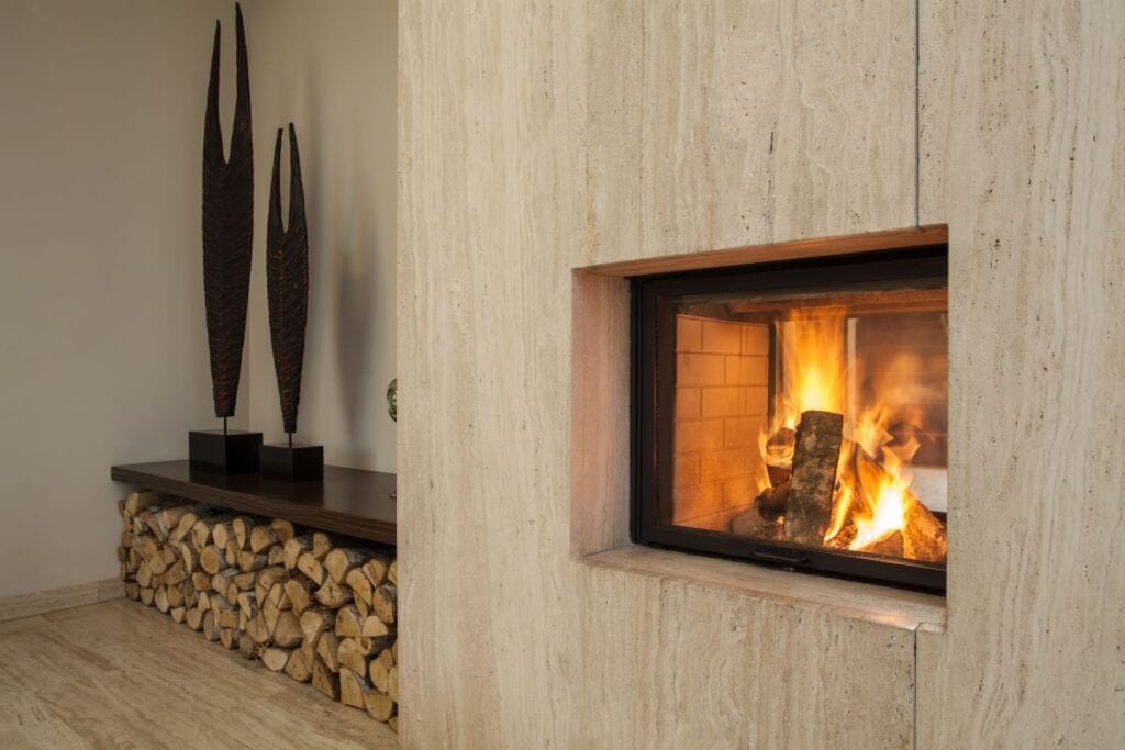 Burning fireplace surrounded by wood