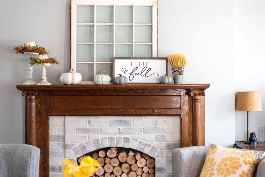 Rustic chic fall decorations on wood and brick fireplace mantel