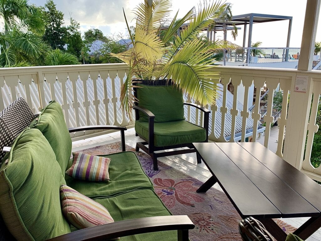 balcony furniture with rugs and throw pillows