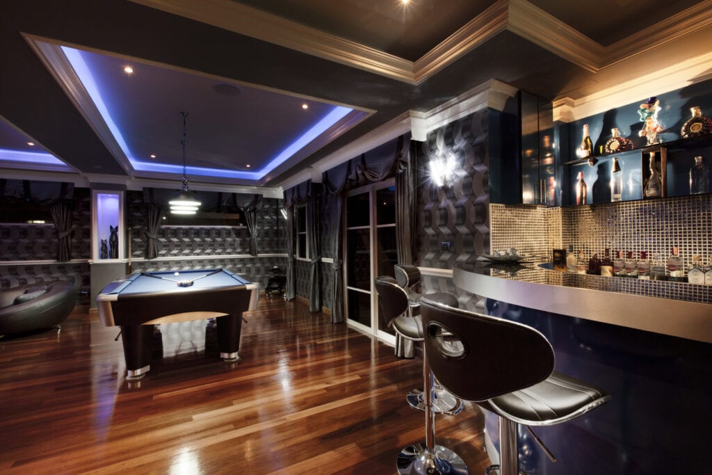 Luxury game room lounge with a bar and pool table