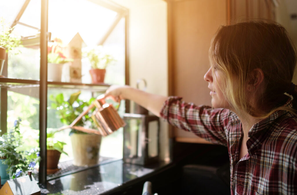 woman watering her herbs