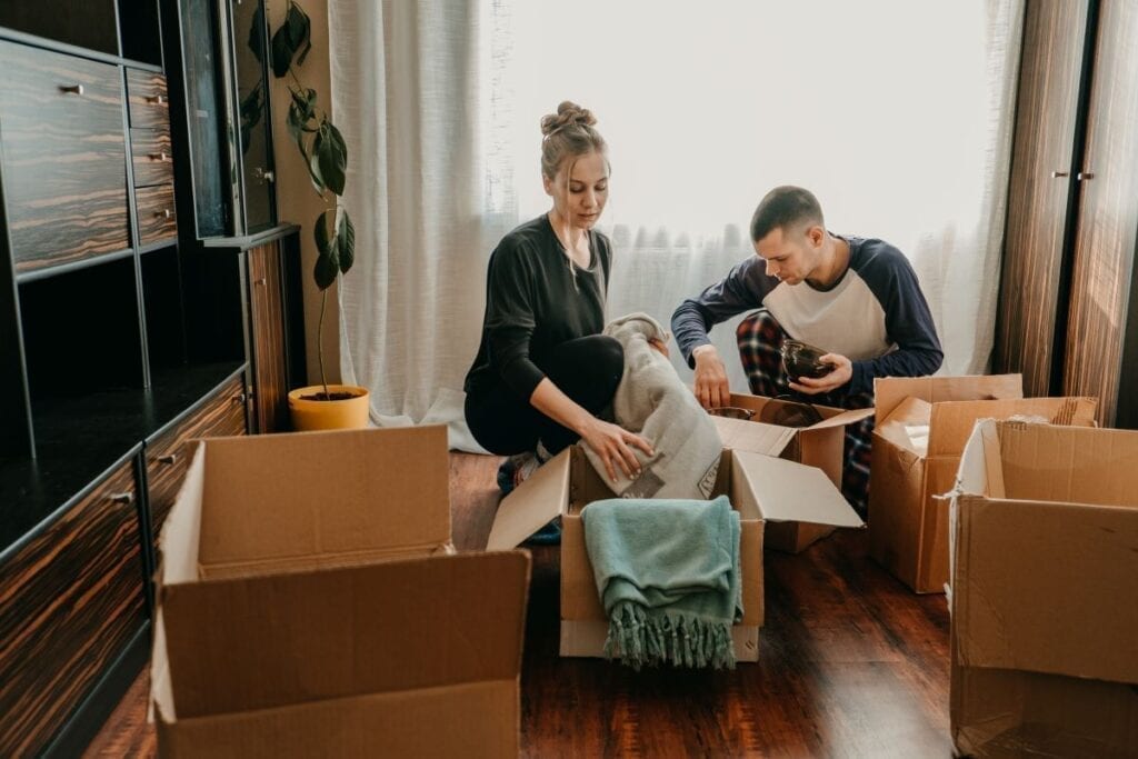 Couple is busy packing boxes to prepare for a move