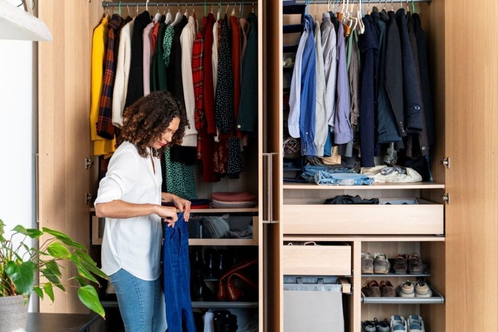 Woman organizing clothes in the closet