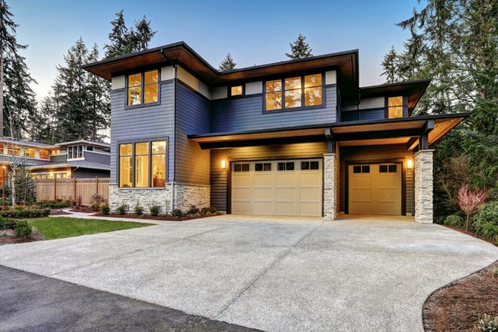 Contemporary house with two car garage at sundown