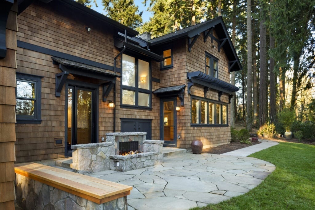 Cabin-style home with fireplace built into back patio