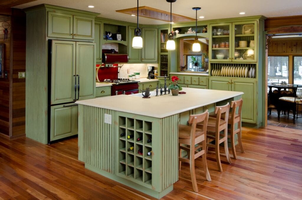 Kitchen with green cabinets and island, built in wine shelves