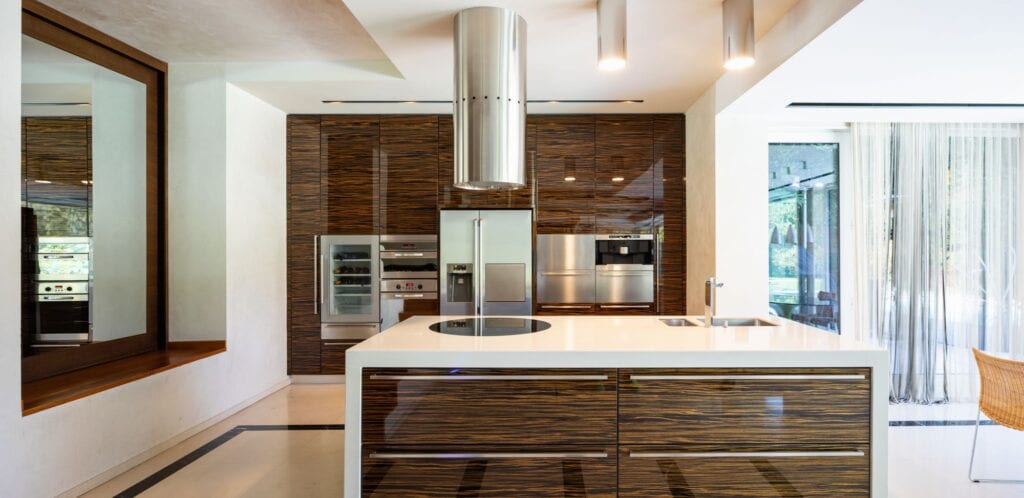 Modern kitchen in wood and marble with wine refrigerator built in