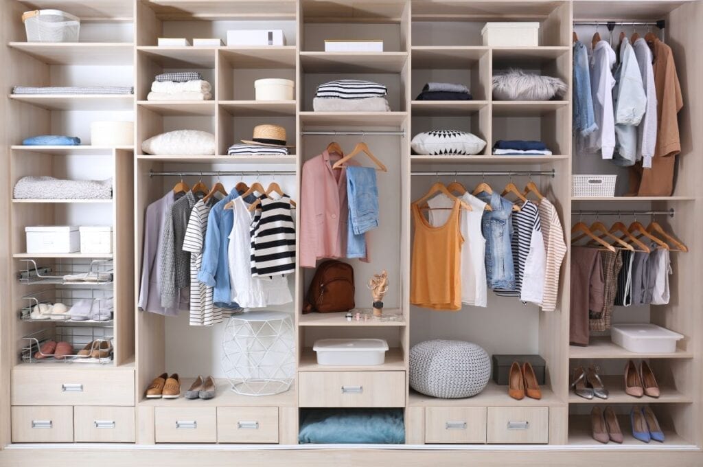 Well-organized closet with stylish clothes and shoes