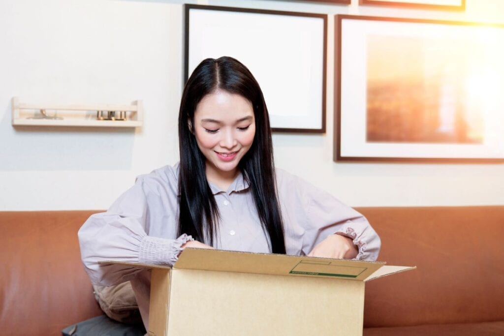 Woman packing a box of essentials for moving