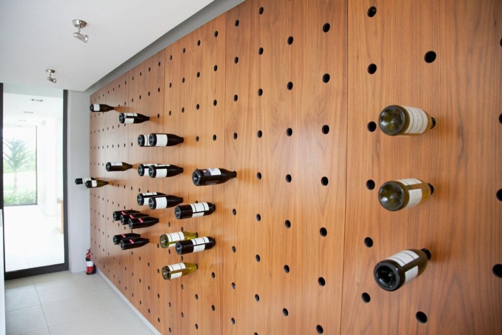 Wine rack is built into wall like a pegboard in a modern home