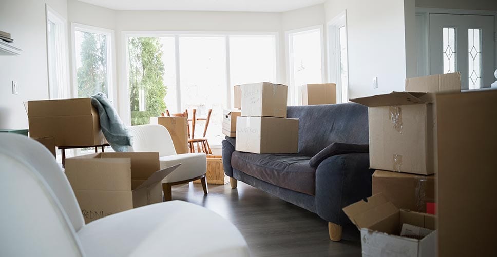 A half-packed living room with boxes that are ready for the moving company