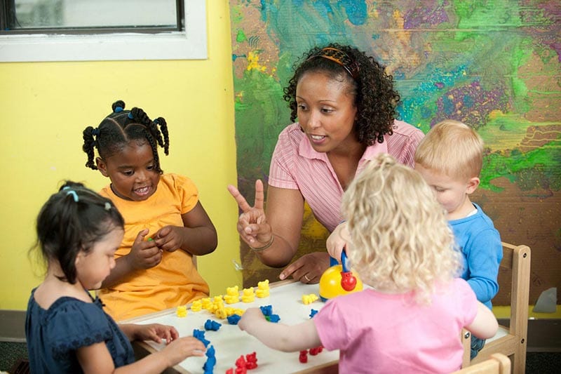 Woman teaching young children