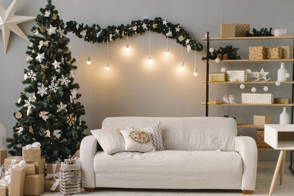 Christmas interior with bright sofa and Christmas tree