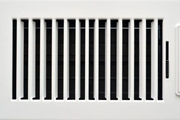 An opaque white heating vent opened