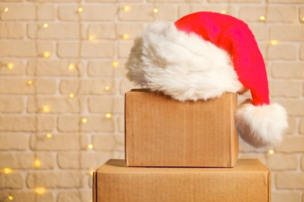 Moving boxes with santa hat on top