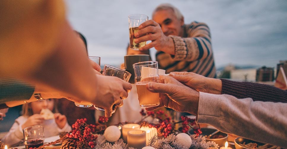 a family gathered around a table doing a cheers